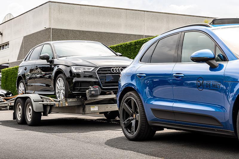 Wagen met pech wordt verplaatst naar de garage van De Mey voor reparatie